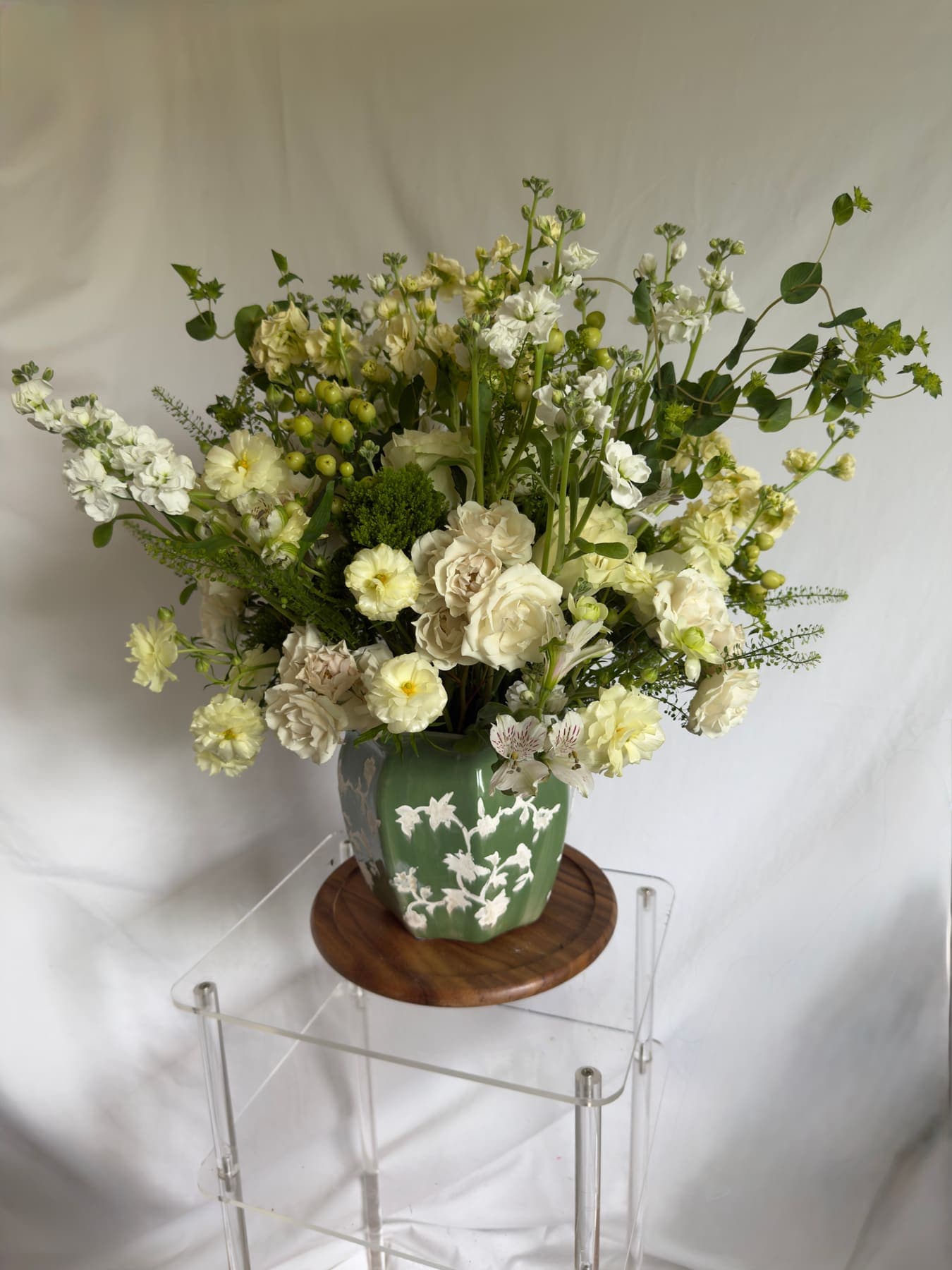 White and cream stock, roses, and alstroemeria in a sage jasperware vase